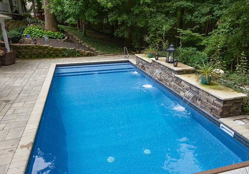 An outdoor pool set in a backyard